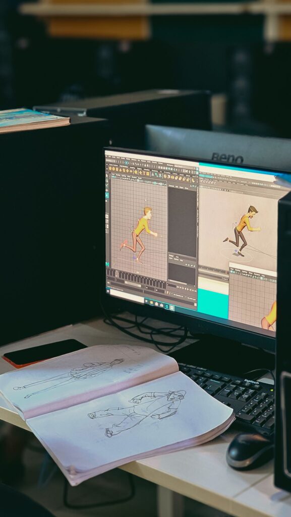Animation studio workspace with sketches and digital character design on screen.